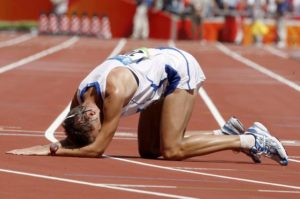 Alex Schwazer of Italy lies on the track after winning gold in the men's 50km walk during the Beijing 2008 Olympic Games in the National Stadium, Beijing, China, 22 August 2008. ANSA/KERIM OKTEN